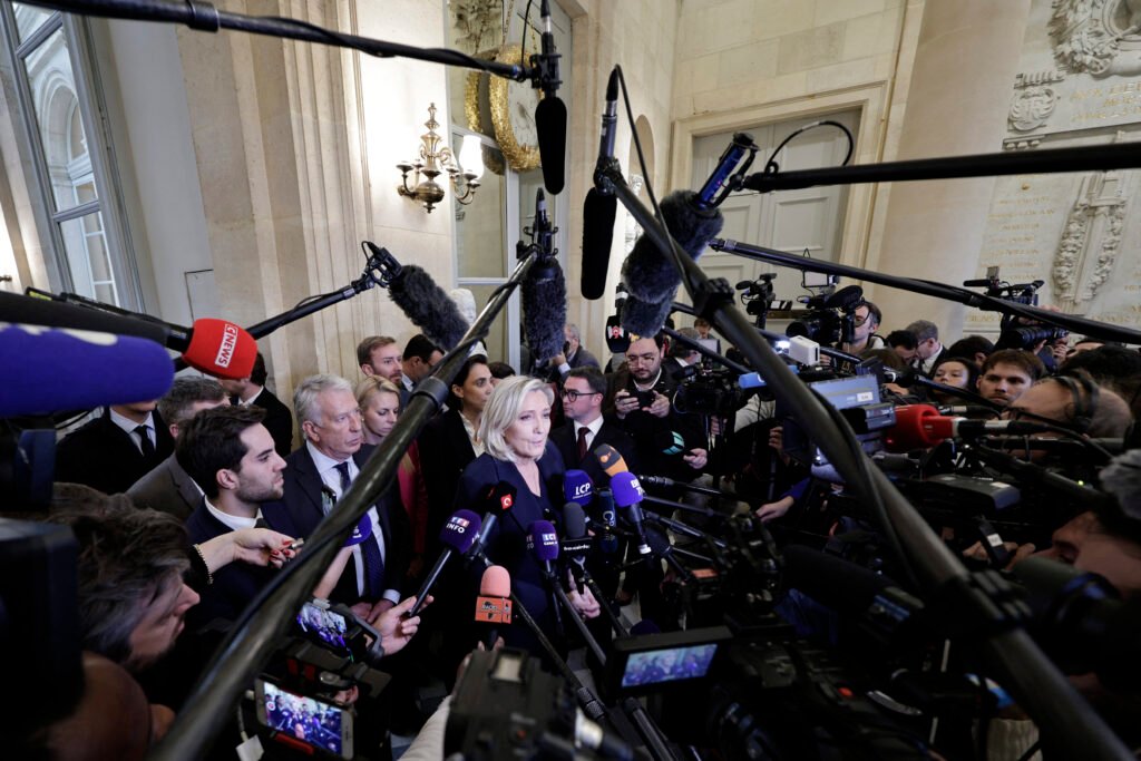Defiant Macron Asserts He Won’t Resign, Reaffirms Support for Barnier’s Survival